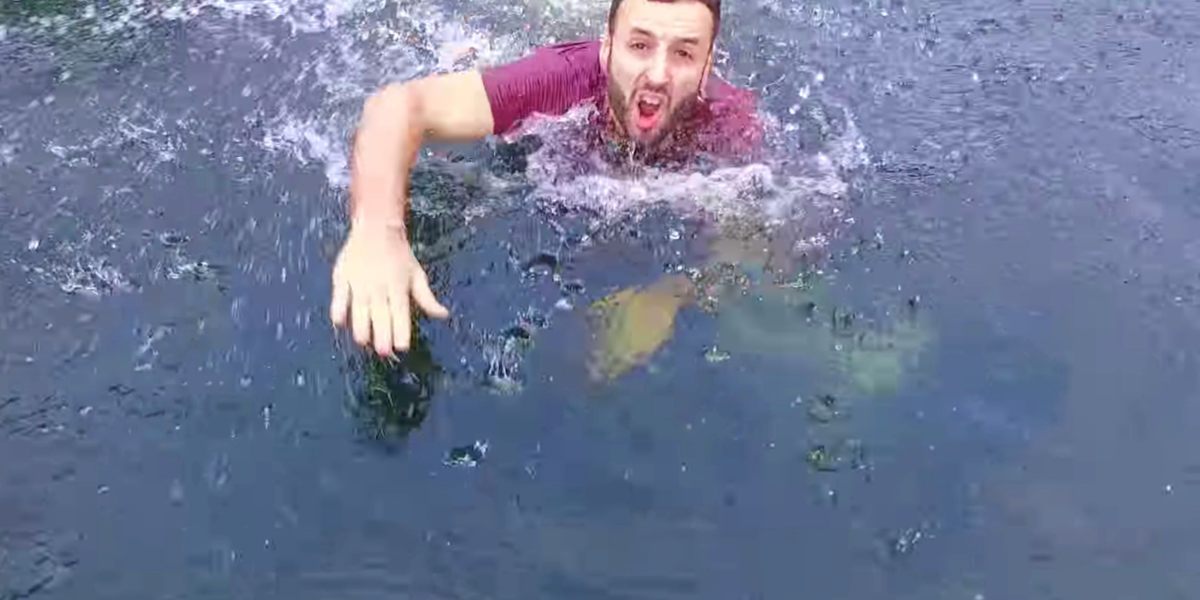 Man jumps in the water to safe drone