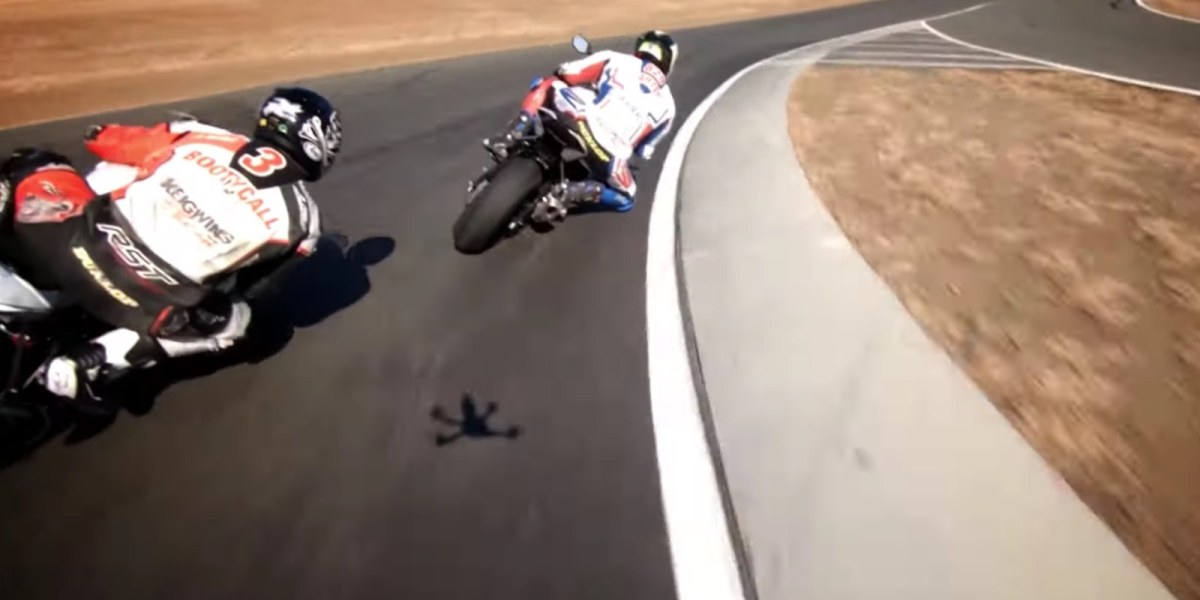 FPV drones race BMW S1000RR motorcycles on track